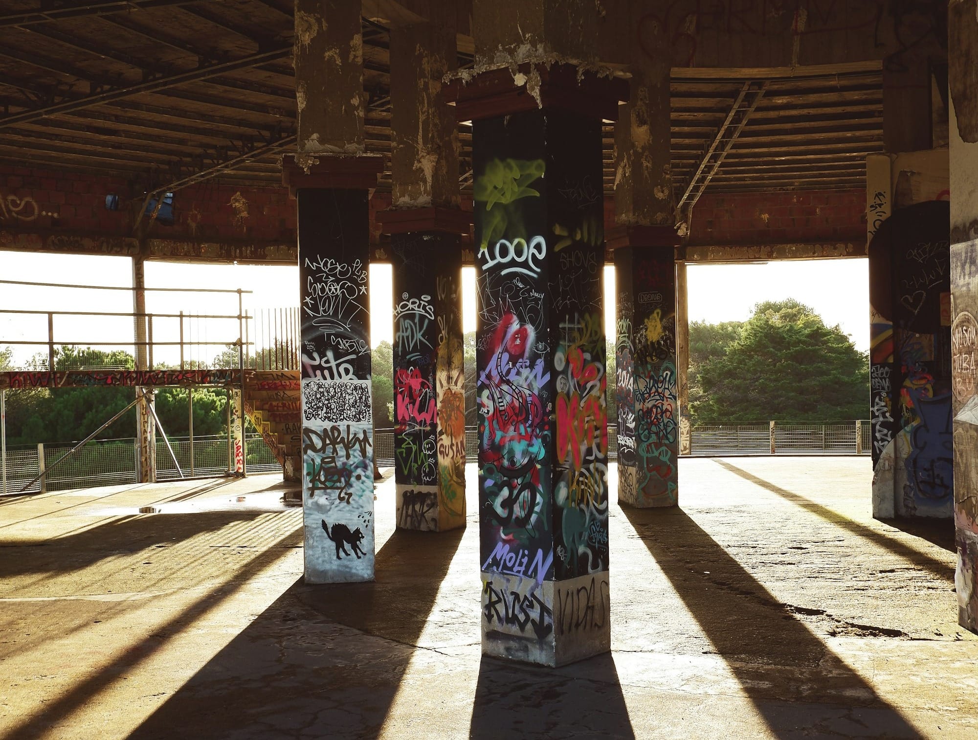 woman in blue and green floral dress standing under brown wooden roof during daytime